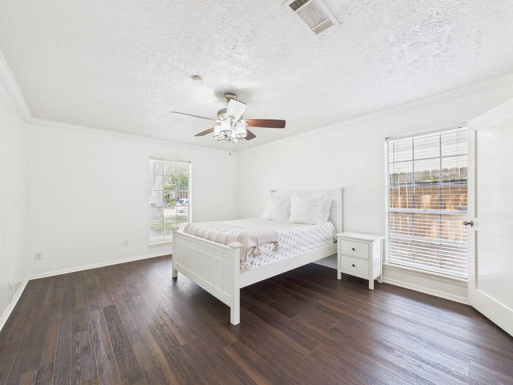 8315 Lichen Lane Spring, TX 77379 - Photo 13 of 31 a spacious bedroom with a bed and a table