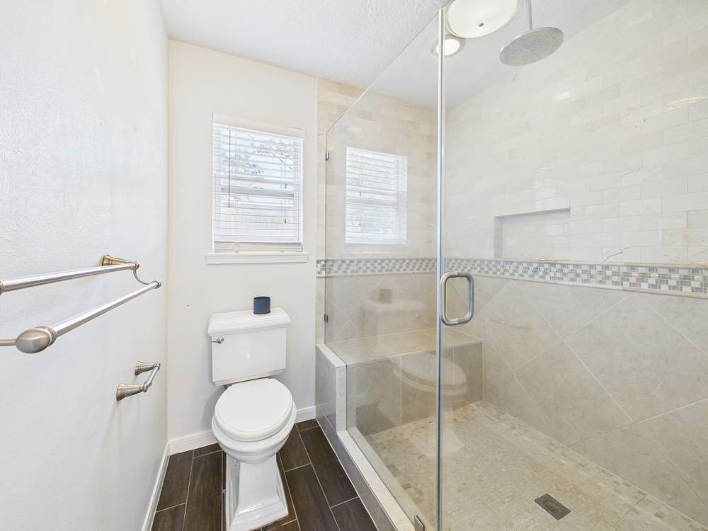 8315 Lichen Lane Spring, TX 77379 - Photo 14 of 31 a bathroom with a toilet and a shower