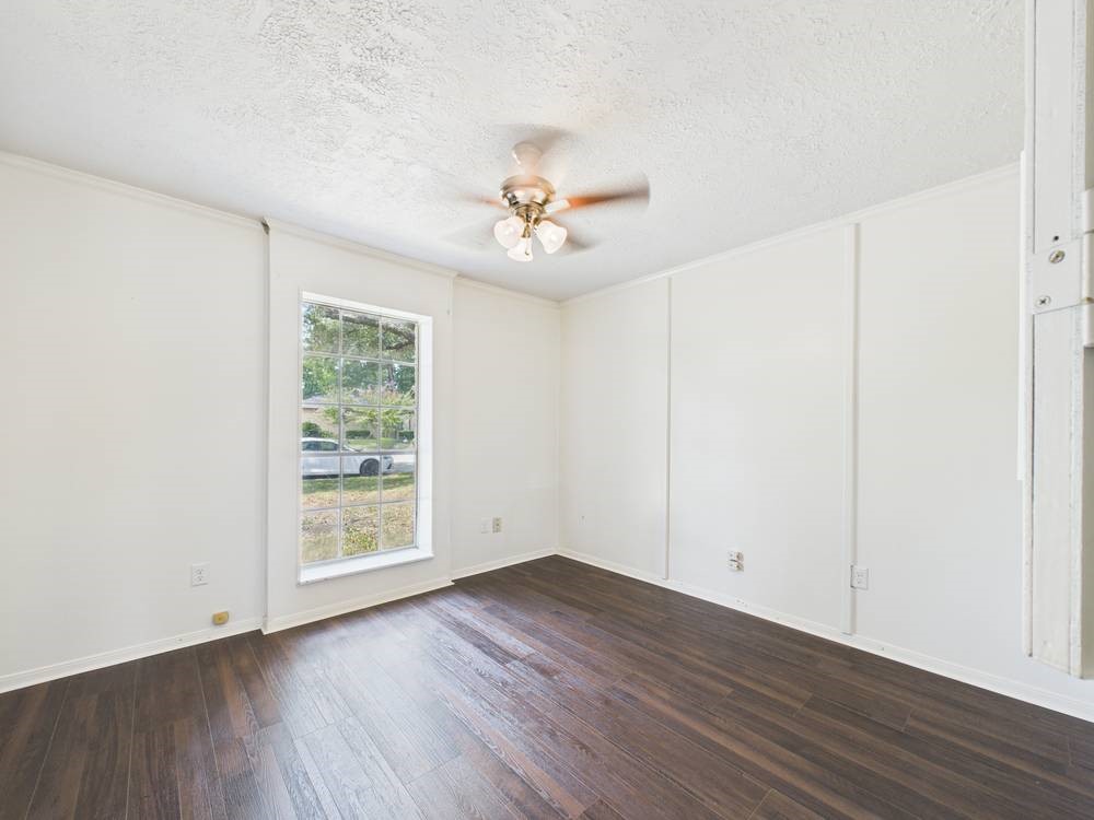8315 Lichen Lane Spring, TX 77379 - Photo 16 of 31 an empty room with wooden floor and windows