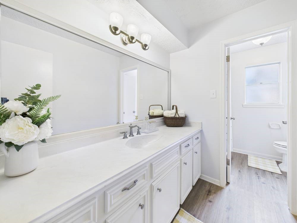 8315 Lichen Lane Spring, TX 77379 - Photo 23 of 31 a bathroom with a sink a toilet and a mirror
