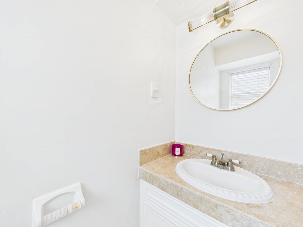 8315 Lichen Lane Spring, TX 77379 - Photo 30 of 31 a bathroom with a sink and a mirror
