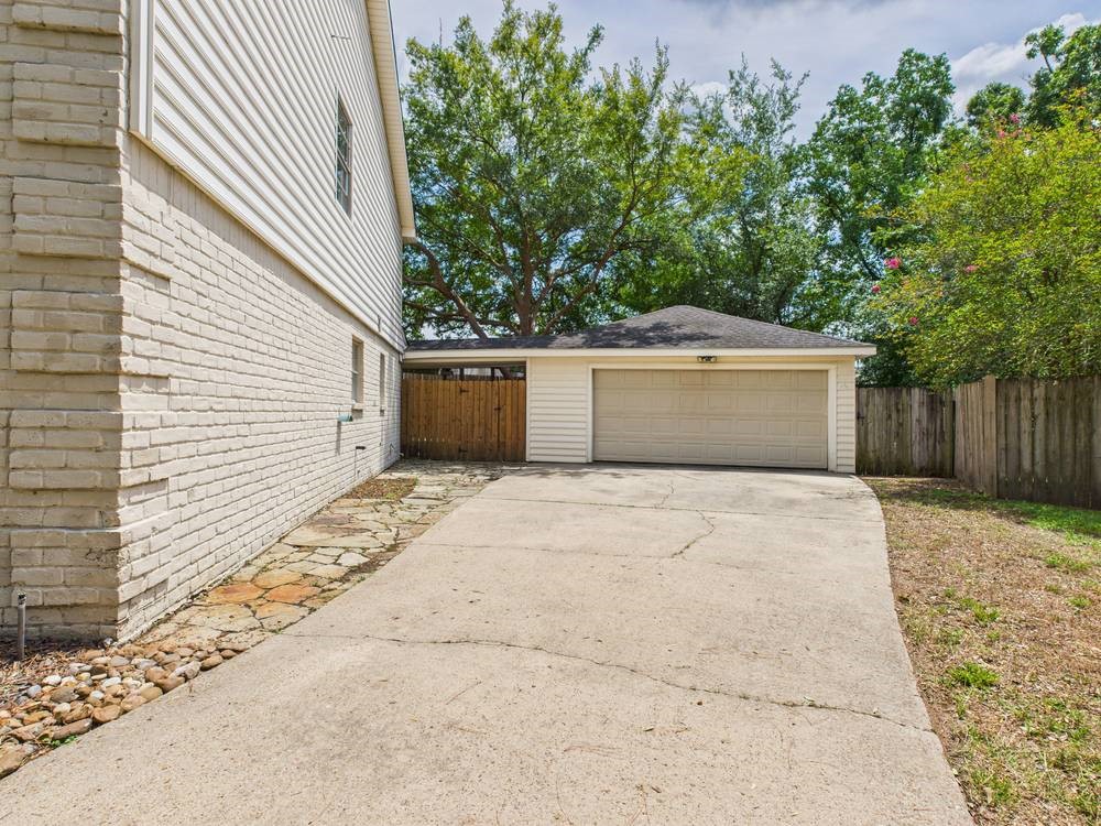 8315 Lichen Lane Spring, TX 77379 - Photo 5 of 31 a front view of a house with a yard and garage
