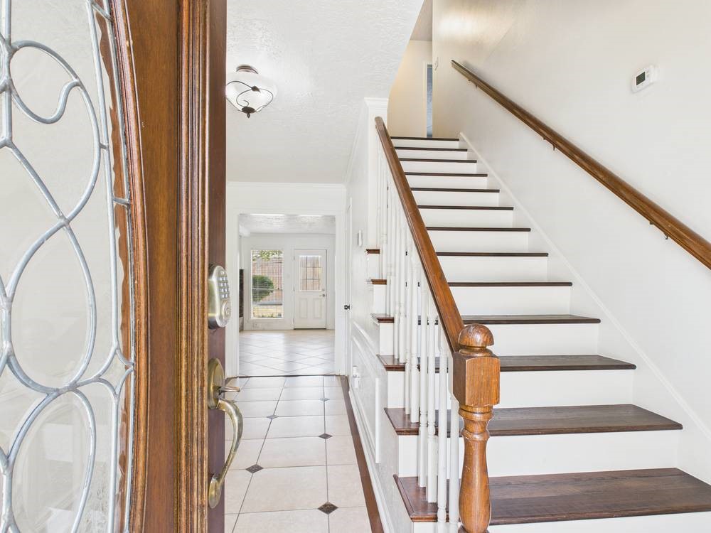 8315 Lichen Lane Spring, TX 77379 - Photo 6 of 31 a view of staircase with wooden floor and white walls