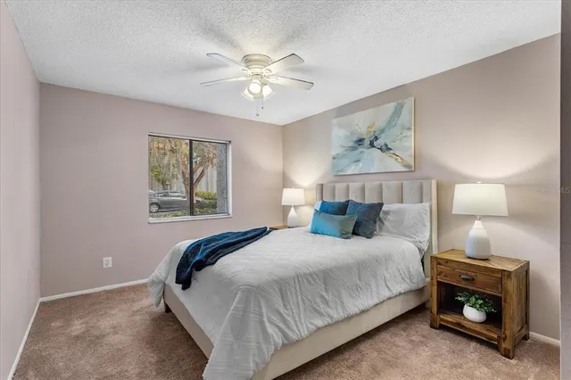 a bedroom with a large bed and a chandelier
