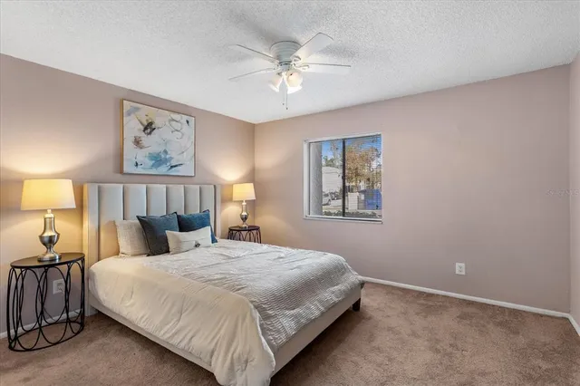 a bedroom with a large bed and a chandelier