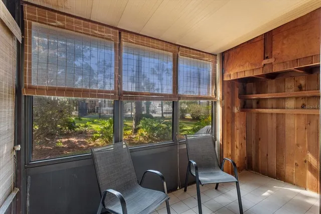 a view of a pathway of a house with a tree in the patio