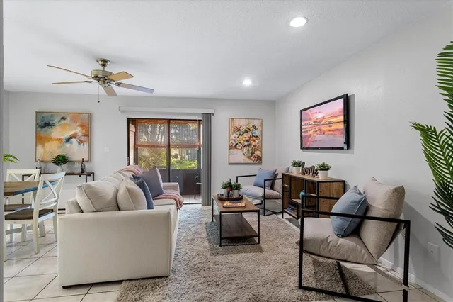 a living room with furniture and a potted plant