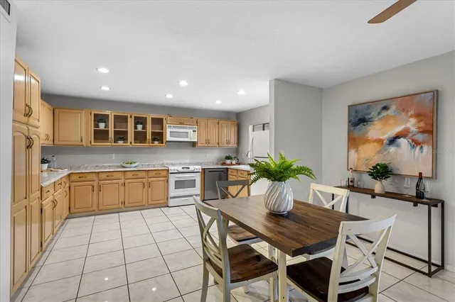 a dining room with furniture and a mirror