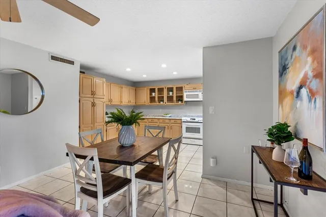 a kitchen with stainless steel appliances granite countertop a refrigerator sink and stove