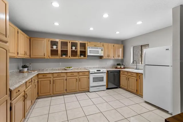 a kitchen with a sink a refrigerator and cabinets