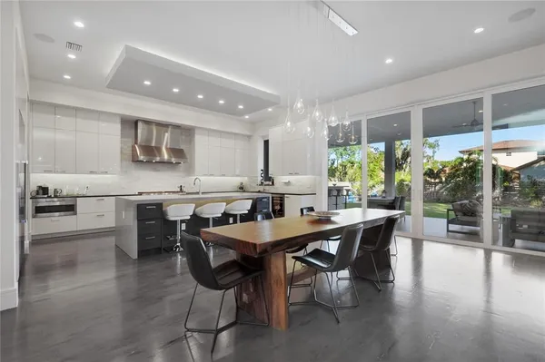 a kitchen with a sink and chairs