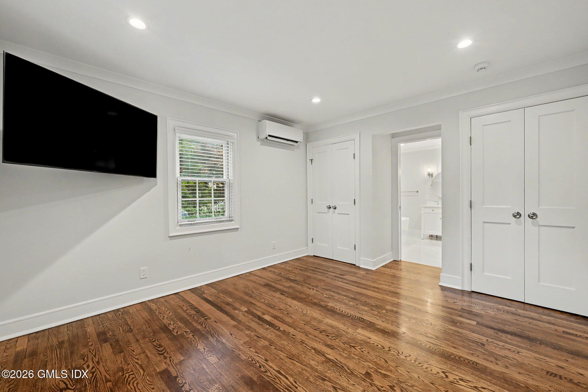 124 Shore Road Old Greenwich, CT 06870 - Photo 15 of 28 a view of empty room with wooden floor and fan