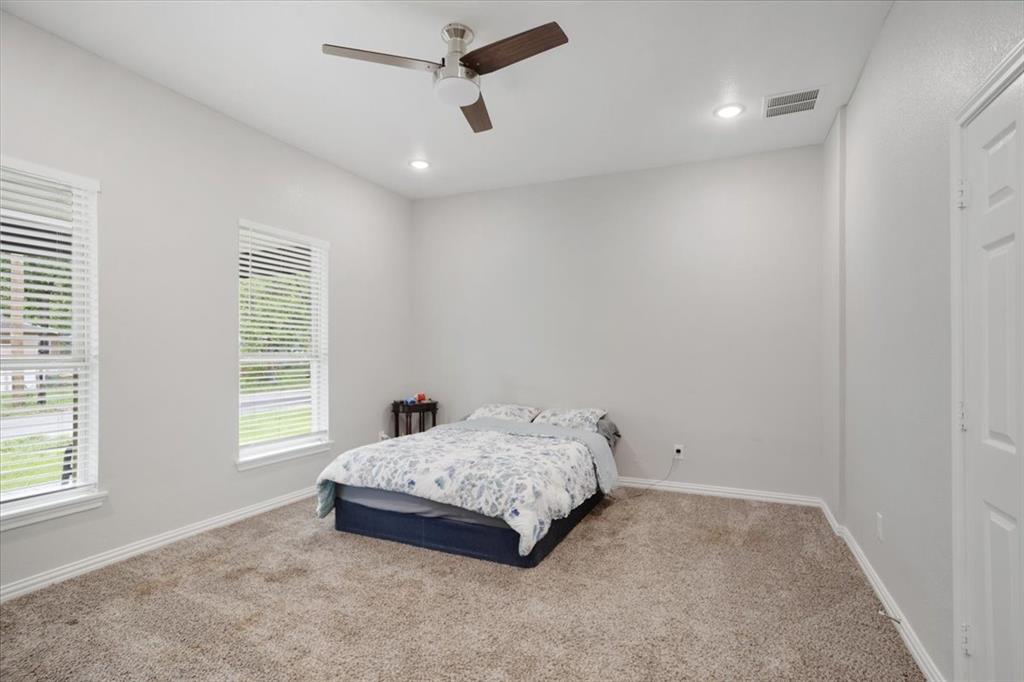 721 Maple Street Bonham, TX 75418 - Photo 12 of 30 a bedroom with a bed and a window
