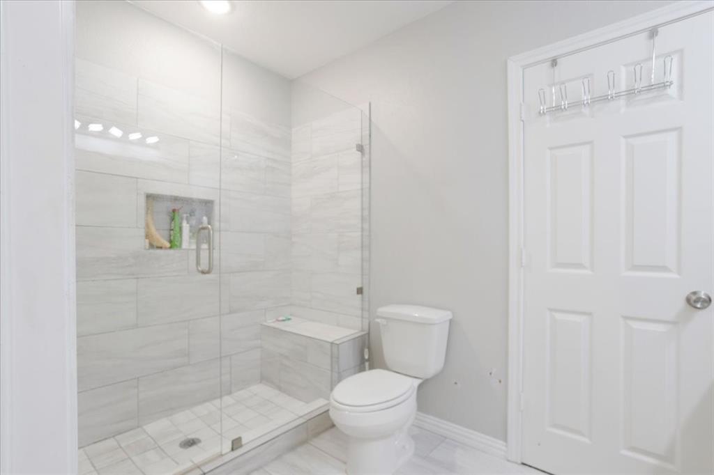 721 Maple Street Bonham, TX 75418 - Photo 14 of 30 a white toilet sitting next to a bathroom sink