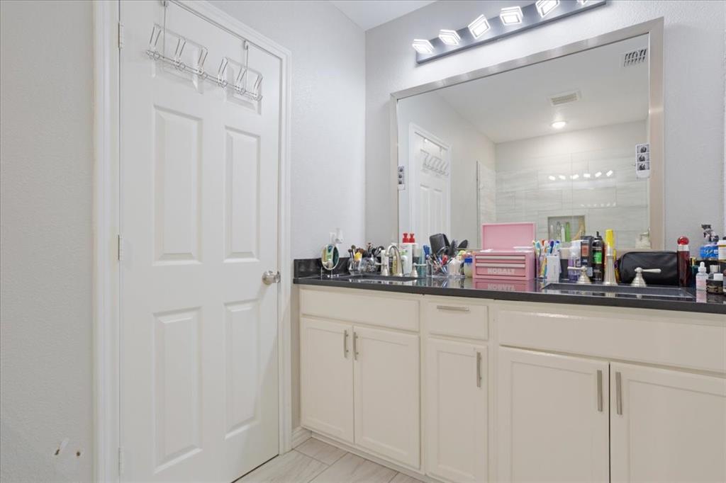 721 Maple Street Bonham, TX 75418 - Photo 15 of 30 a bathroom with a sink and a mirror