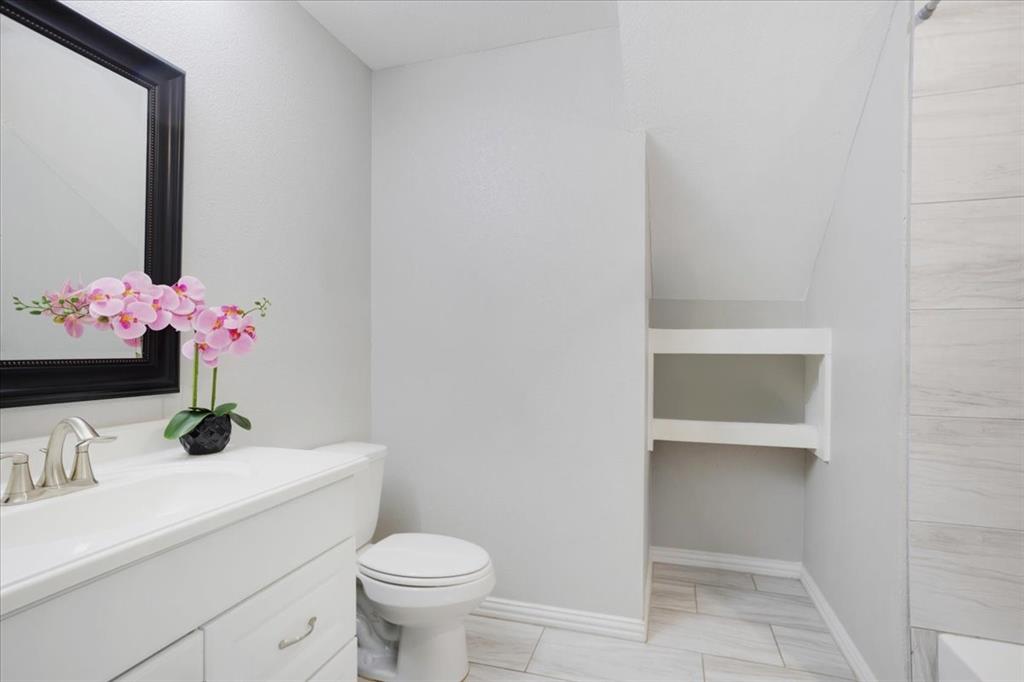 721 Maple Street Bonham, TX 75418 - Photo 26 of 30 a bathroom with a sink vanity and toilet