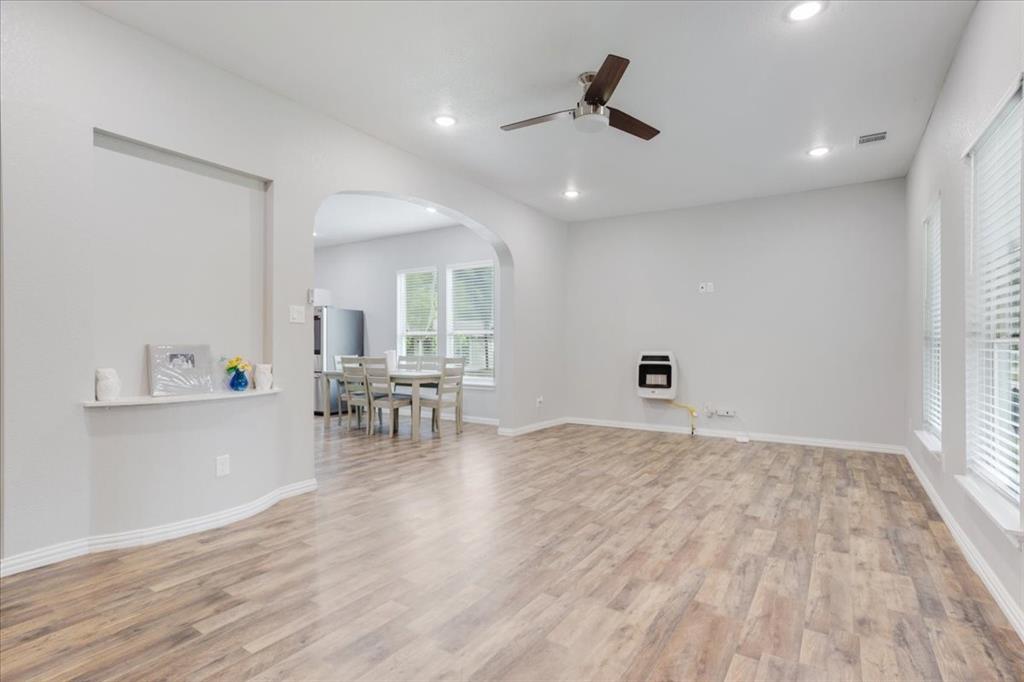 721 Maple Street Bonham, TX 75418 - Photo 6 of 30 a view of kitchen and dining room with wooden floor