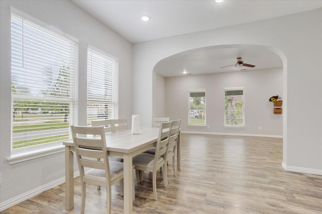 721 Maple Street Bonham, TX 75418 - Photo 9 of 30 a view of a dining room with furniture and wooden floor