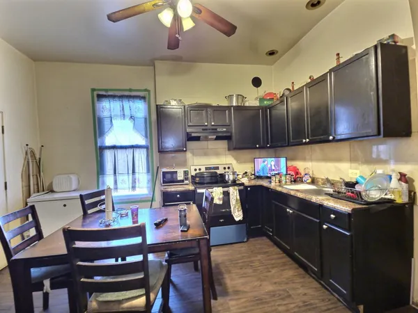 a kitchen with lots of wooden furniture cabinets and stainless steel appliances