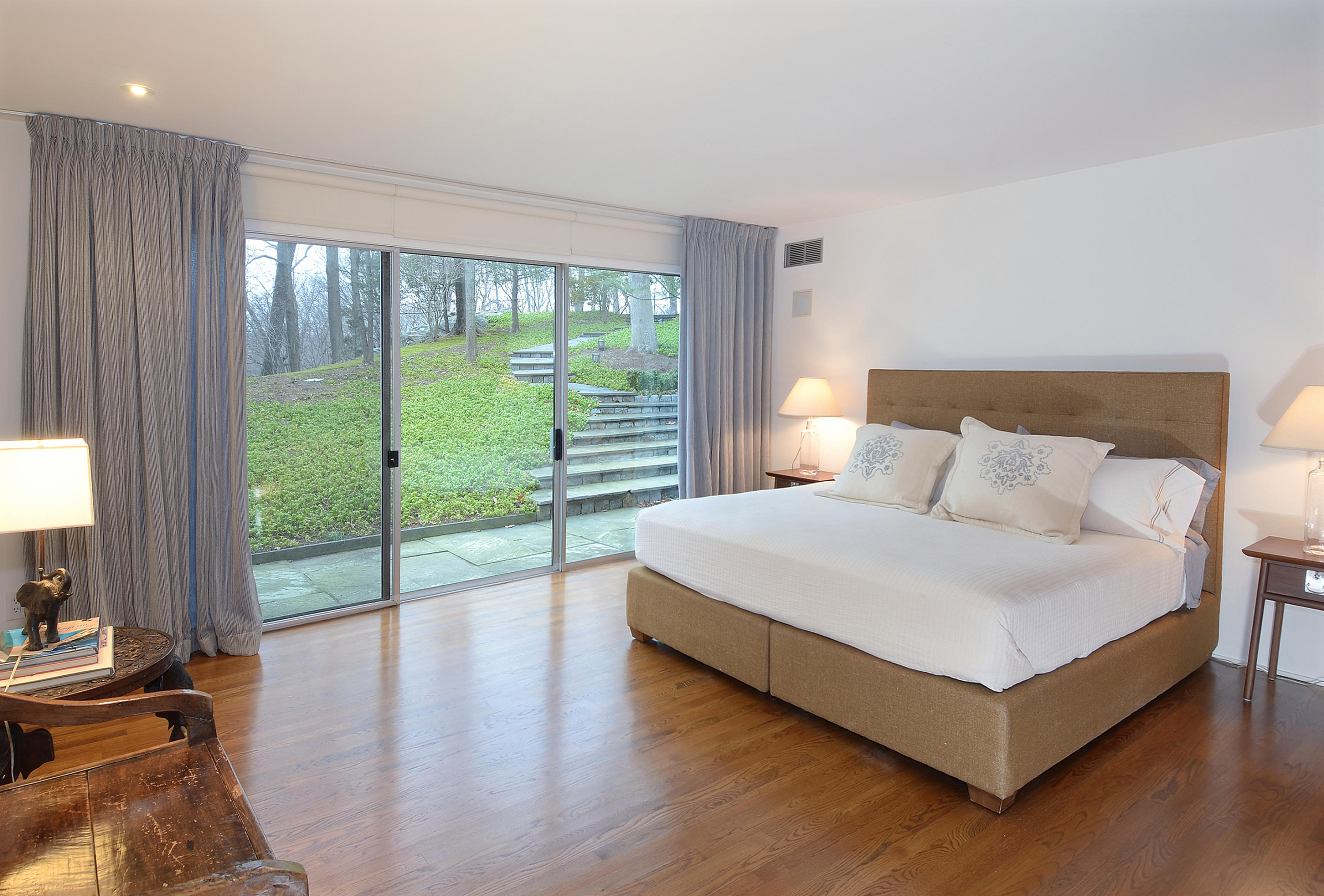 1380 Ponus Ridge Road New Canaan, CT 06840 - Photo 11 of 22 a bedroom with a bed and a large window