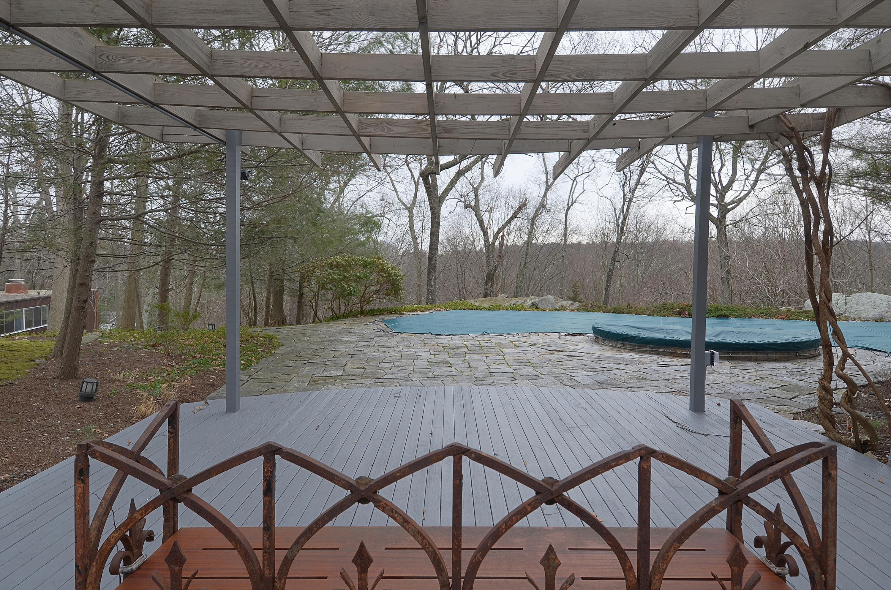 1380 Ponus Ridge Road New Canaan, CT 06840 - Photo 22 of 22 a view of a patio with table and chairs and wooden fence