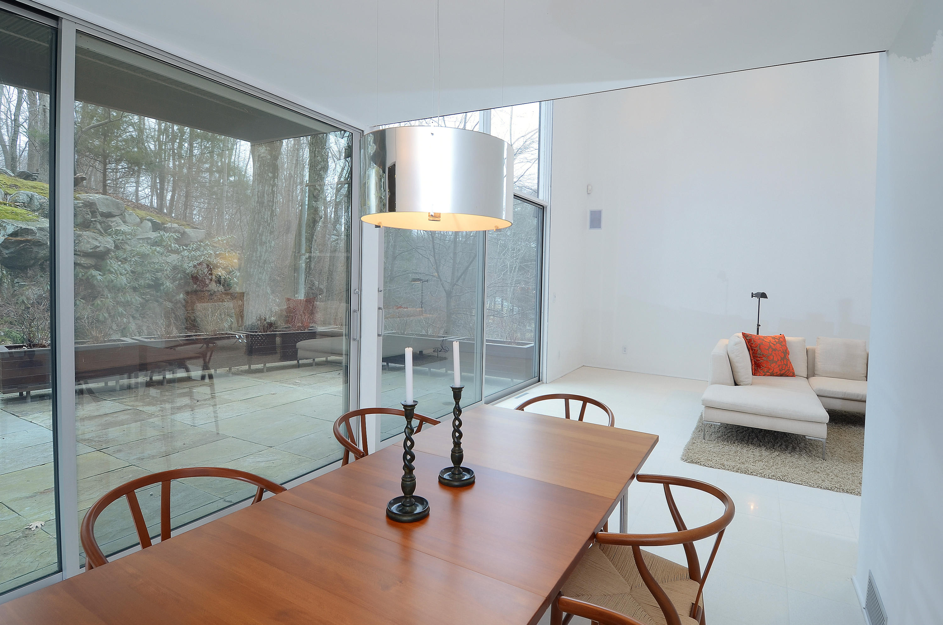 1380 Ponus Ridge Road New Canaan, CT 06840 - Photo 8 of 22 a view of a dining room with furniture a chandelier and wooden floor