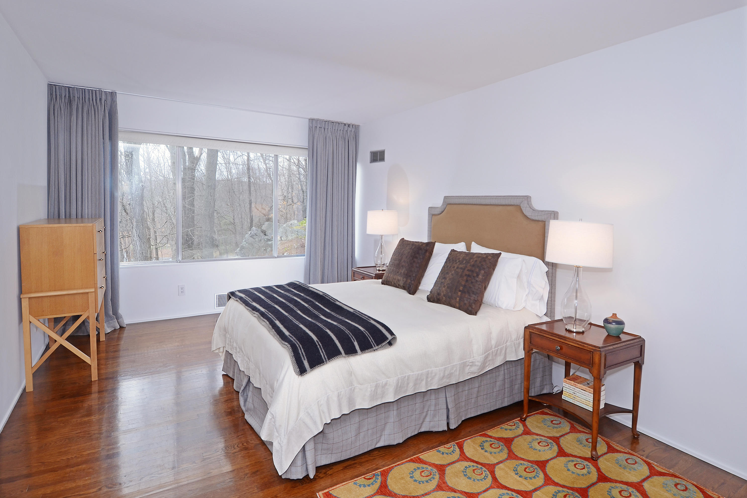 1380 Ponus Ridge Road New Canaan, CT 06840 - Photo 10 of 22 a bedroom with a bed and wooden floor