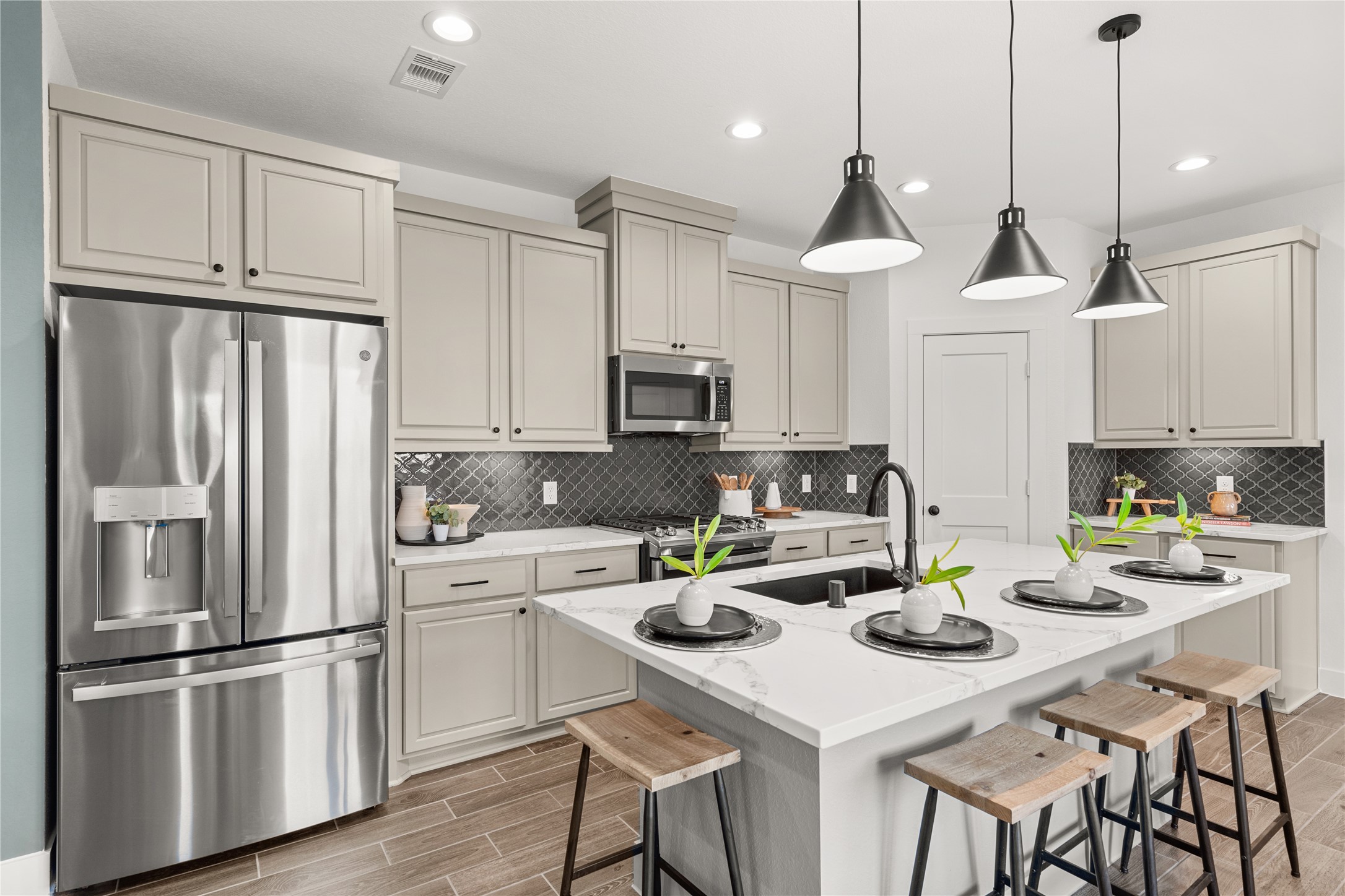 5255 Celestial Court Iowa Colony, TX 77583 - Photo 14 of 29 a kitchen with stainless steel appliances a stove a refrigerator a sink a stove a dining table and chairs
