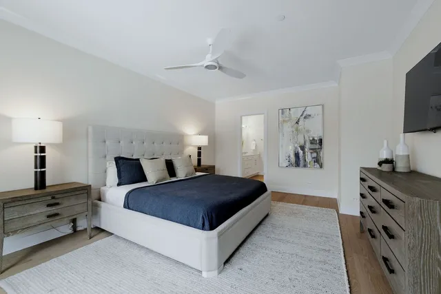 a living room with a bed and a flat screen tv