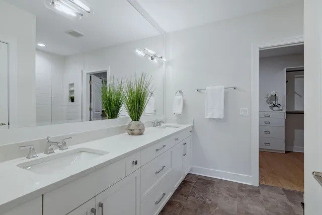 a bathroom with a double vanity sink and a mirror