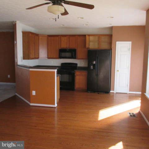 604 Moody Road Baltimore, MD 21220 - Photo 8 of 21 a kitchen with stainless steel appliances granite countertop a refrigerator and a stove