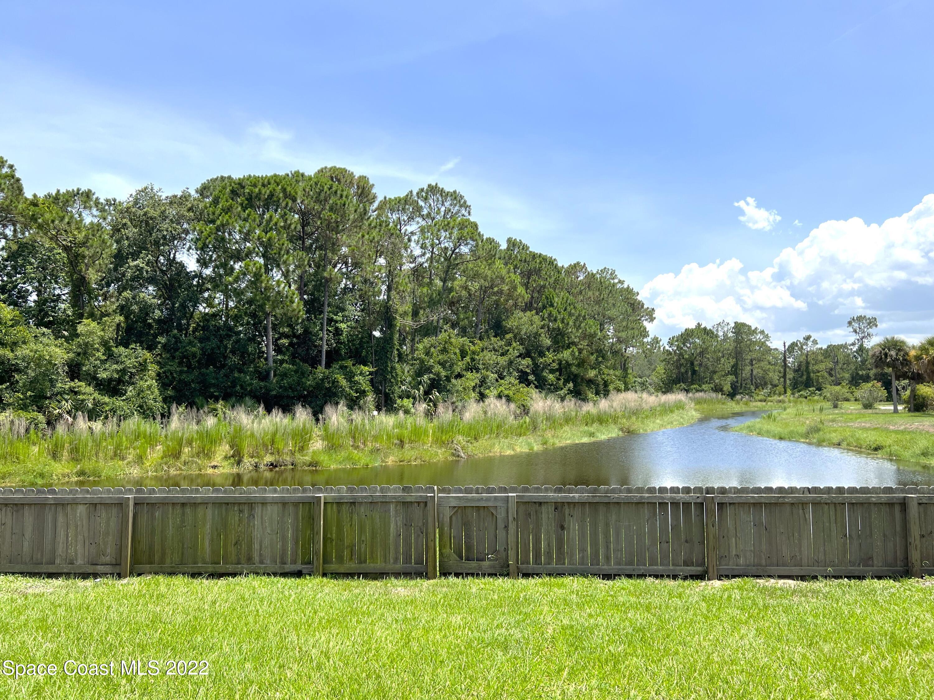 449 Alison Street Titusville, FL 32780 - Photo 11 of 18 a view of a lake with a yard