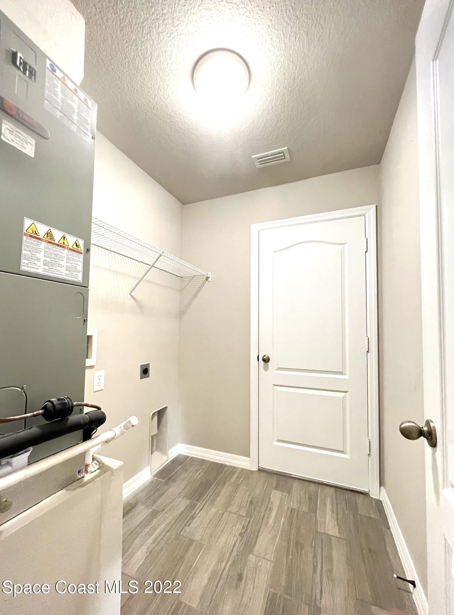 449 Alison Street Titusville, FL 32780 - Photo 18 of 18 a view of a room with a wooden floor