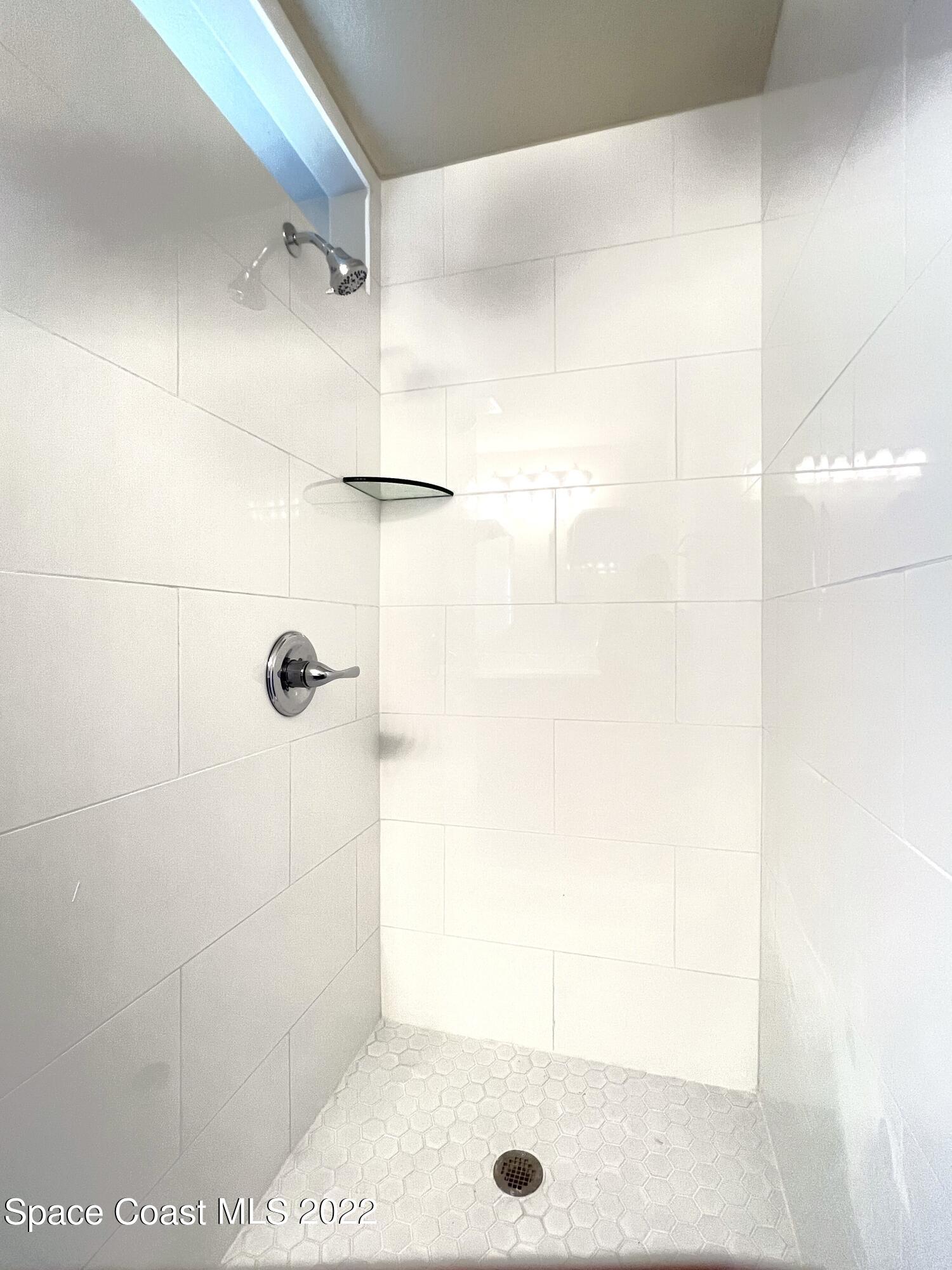 449 Alison Street Titusville, FL 32780 - Photo 6 of 18 a bathroom with a shower