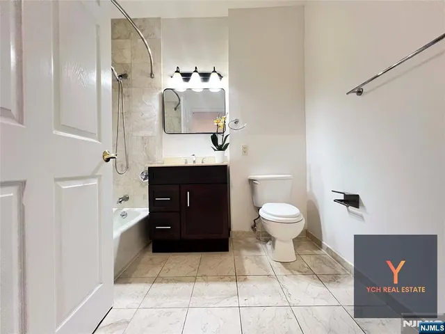 a bathroom with a toilet a sink and mirror
