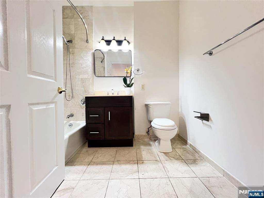 1100 River Road, Unit 206 Edgewater, NJ 07020 - Photo 13 of 13 a bathroom with a toilet sink and mirror