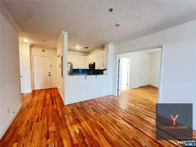 a view of a bedroom with wooden floor and bedroom