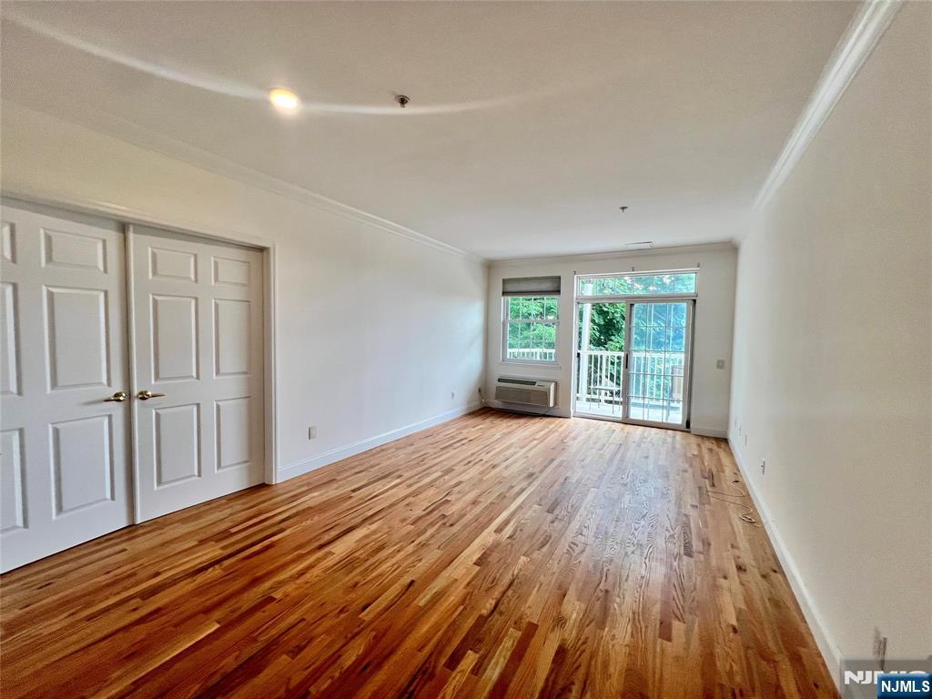 1100 River Road, Unit 206 Edgewater, NJ 07020 - Photo 5 of 13 wooden floor in an empty room with a window