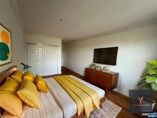 a bedroom with a bed and a television