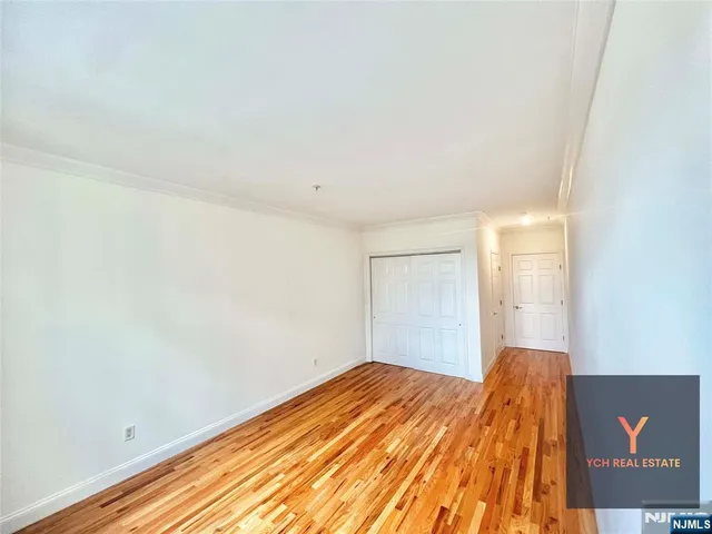 a view of a room with wooden floor and fan