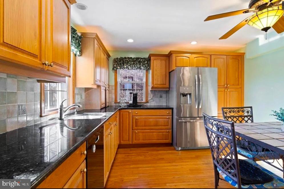 64 Warrior Road Drexel Hill, PA 19026 - Photo 2 of 11 a kitchen with stainless steel appliances granite countertop a refrigerator a sink a stove and island