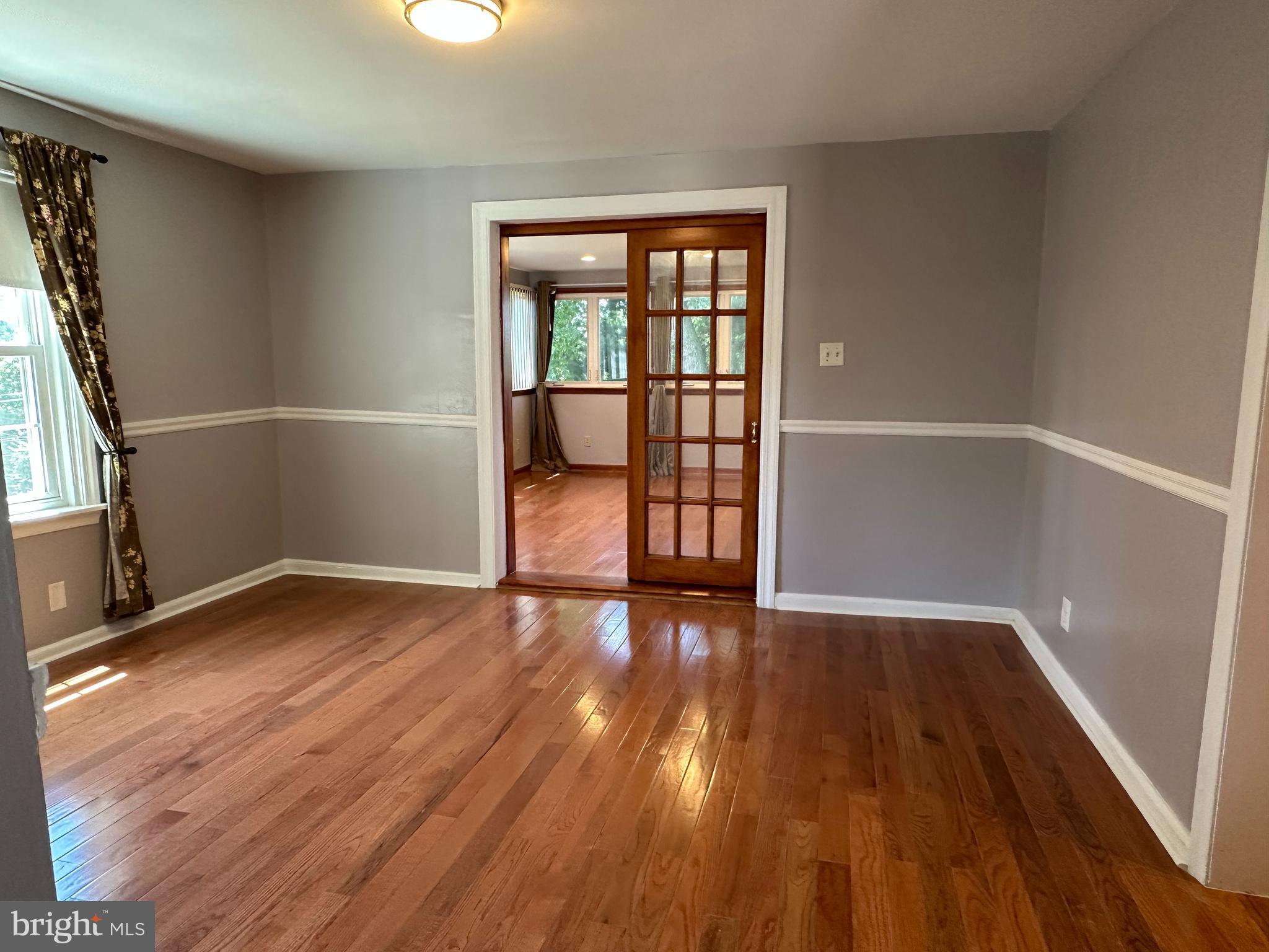 64 Warrior Road Drexel Hill, PA 19026 - Photo 5 of 11 an empty room with wooden floor and windows