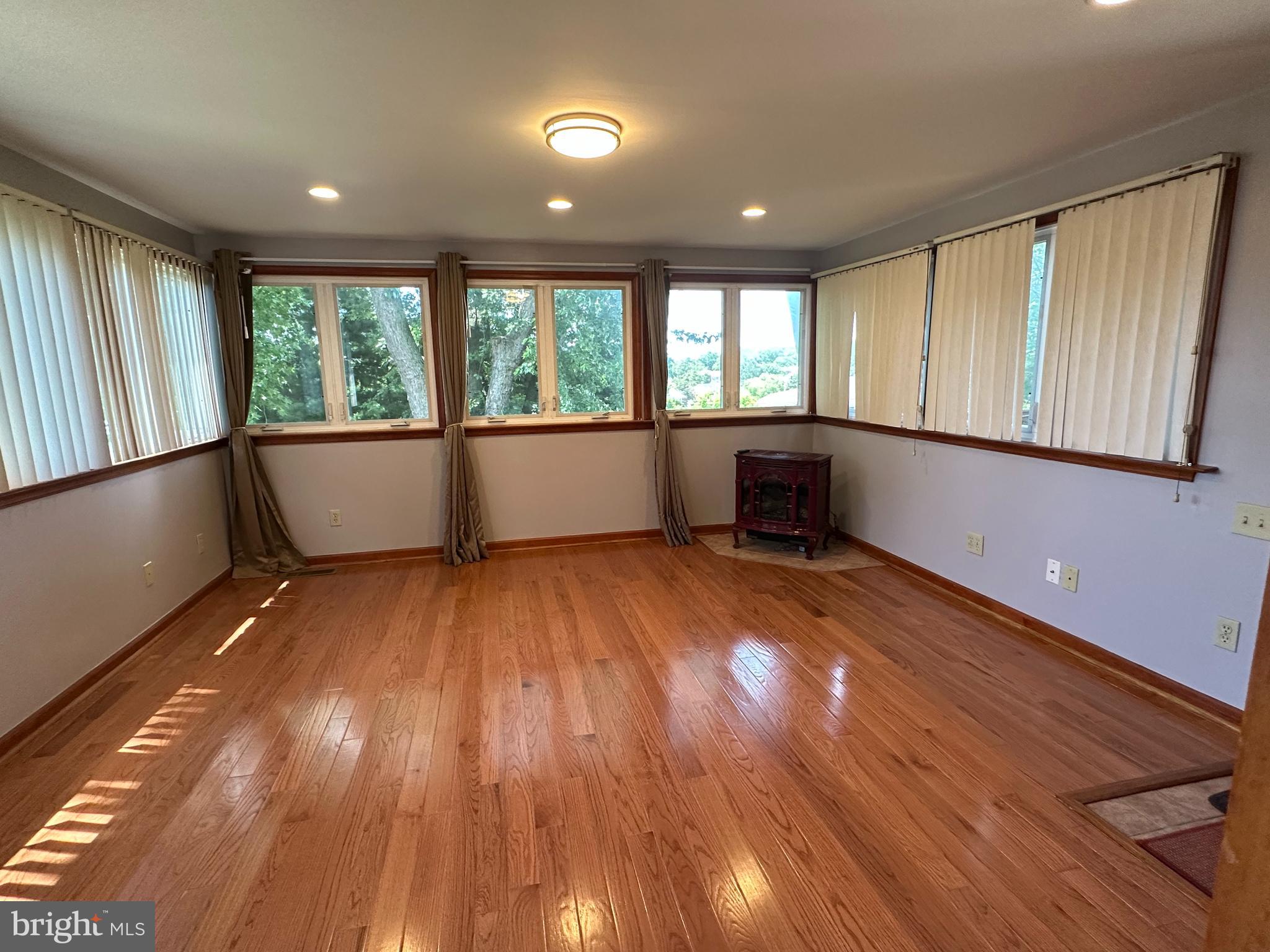 64 Warrior Road Drexel Hill, PA 19026 - Photo 6 of 11 a view of an empty room with wooden floor and a window