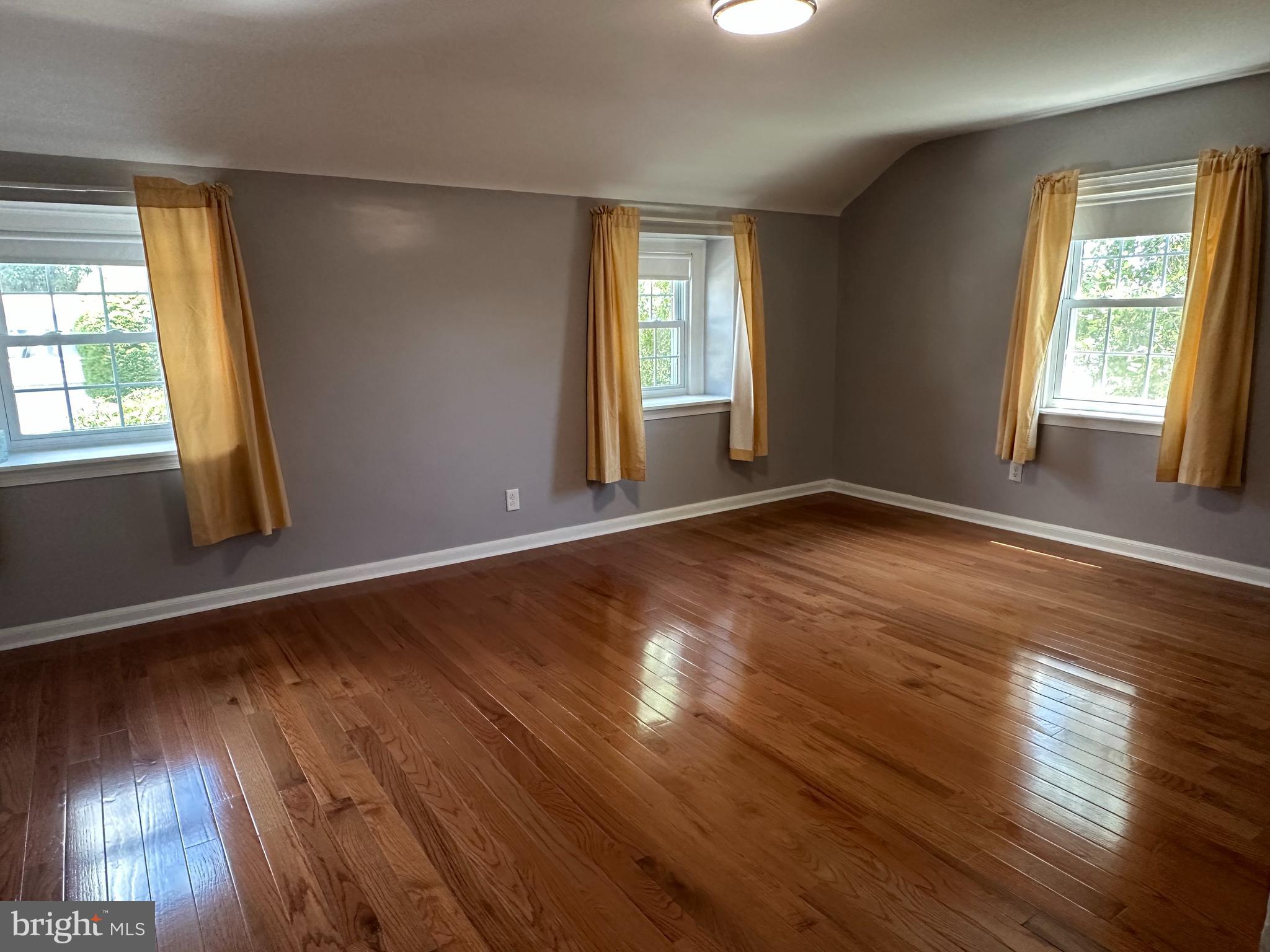 64 Warrior Road Drexel Hill, PA 19026 - Photo 7 of 11 a view of an empty room with wooden floor and a window
