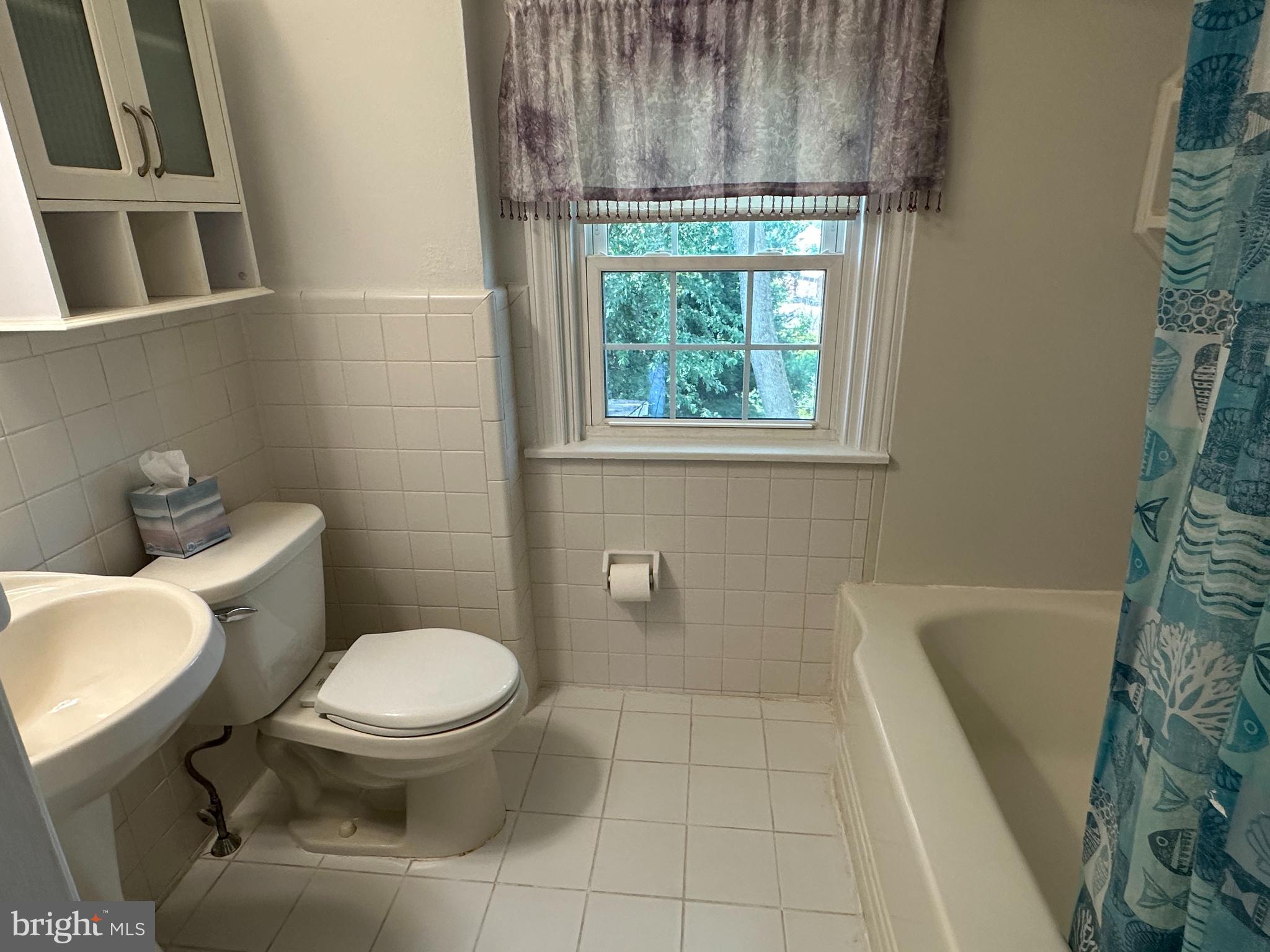 64 Warrior Road Drexel Hill, PA 19026 - Photo 10 of 11 a white toilet sitting next to a bath tub