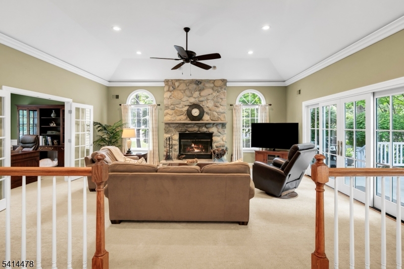 33 St Nickolas Way Bernards, NJ 07920 - Photo 11 of 50 a living room with furniture a flat screen tv and a fireplace