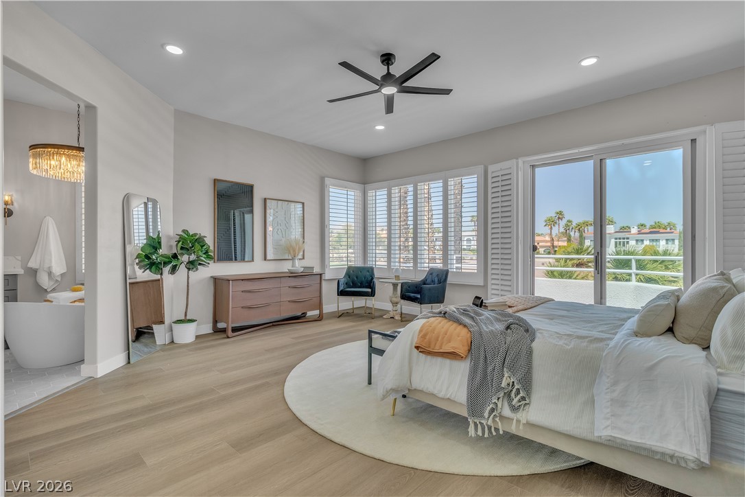 8848 Rainbow Ridge Drive Las Vegas, NV 89117 - Photo 26 of 43 Well-lit primary bedroom featuring wide plank flooring and direct access to a private balcony.