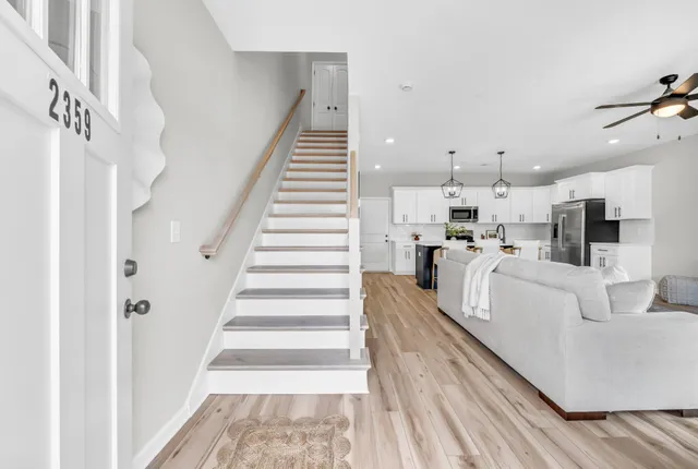 a view of a living room with white walls