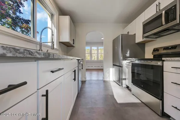 a kitchen with stainless steel appliances granite countertop a stove and a sink