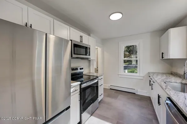 a kitchen with a refrigerator stove and sink